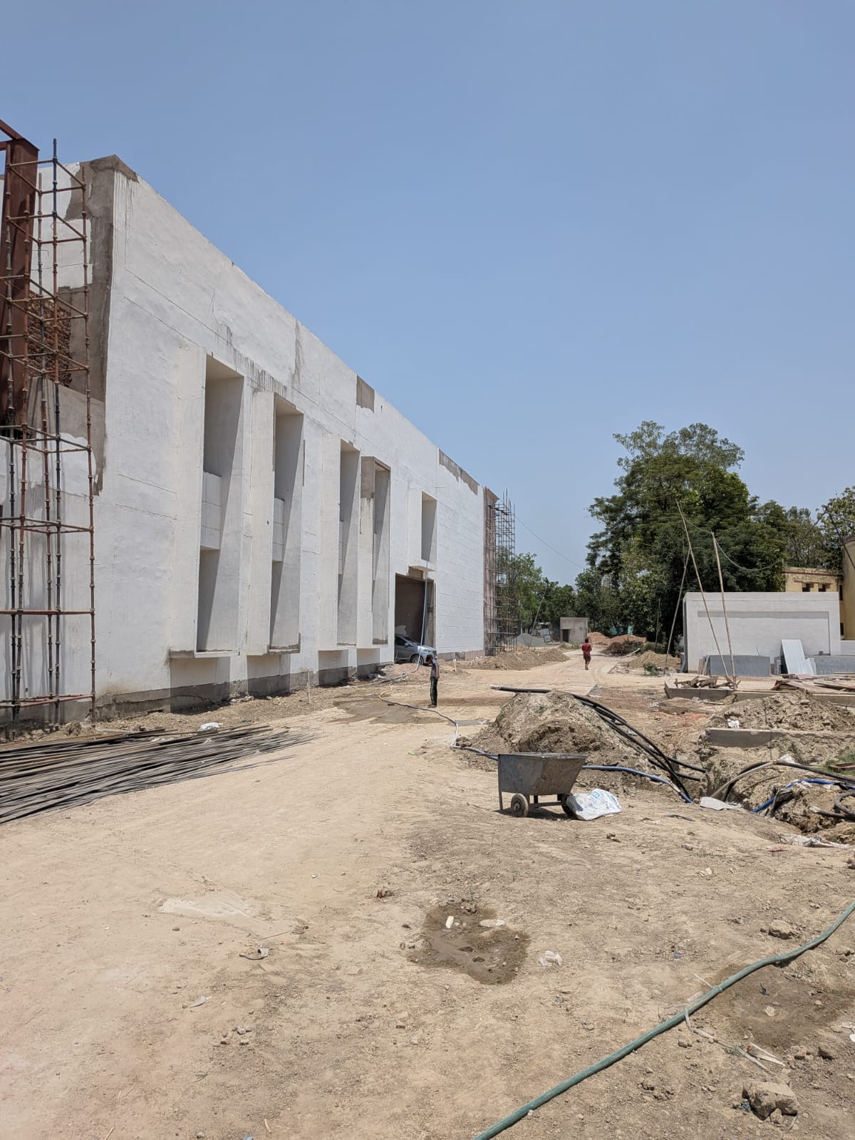 Mainpuri Cultural Centre under construction, with the main building, scaffolding, and site works visible.